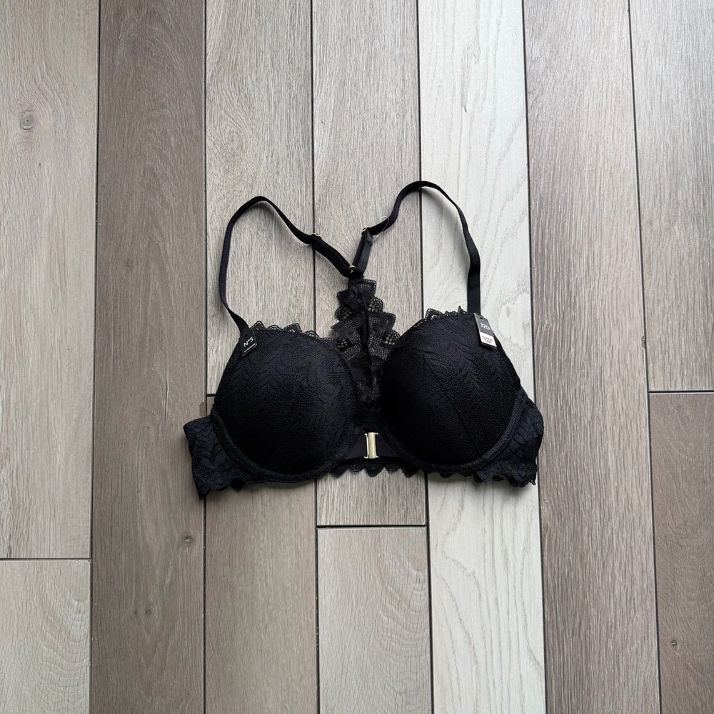 Etam black lace bra with adjustable straps and hook closure.